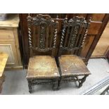 A pair of carved oak hall chairs