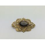 A 9ct gold piercework brooch set with a central sm