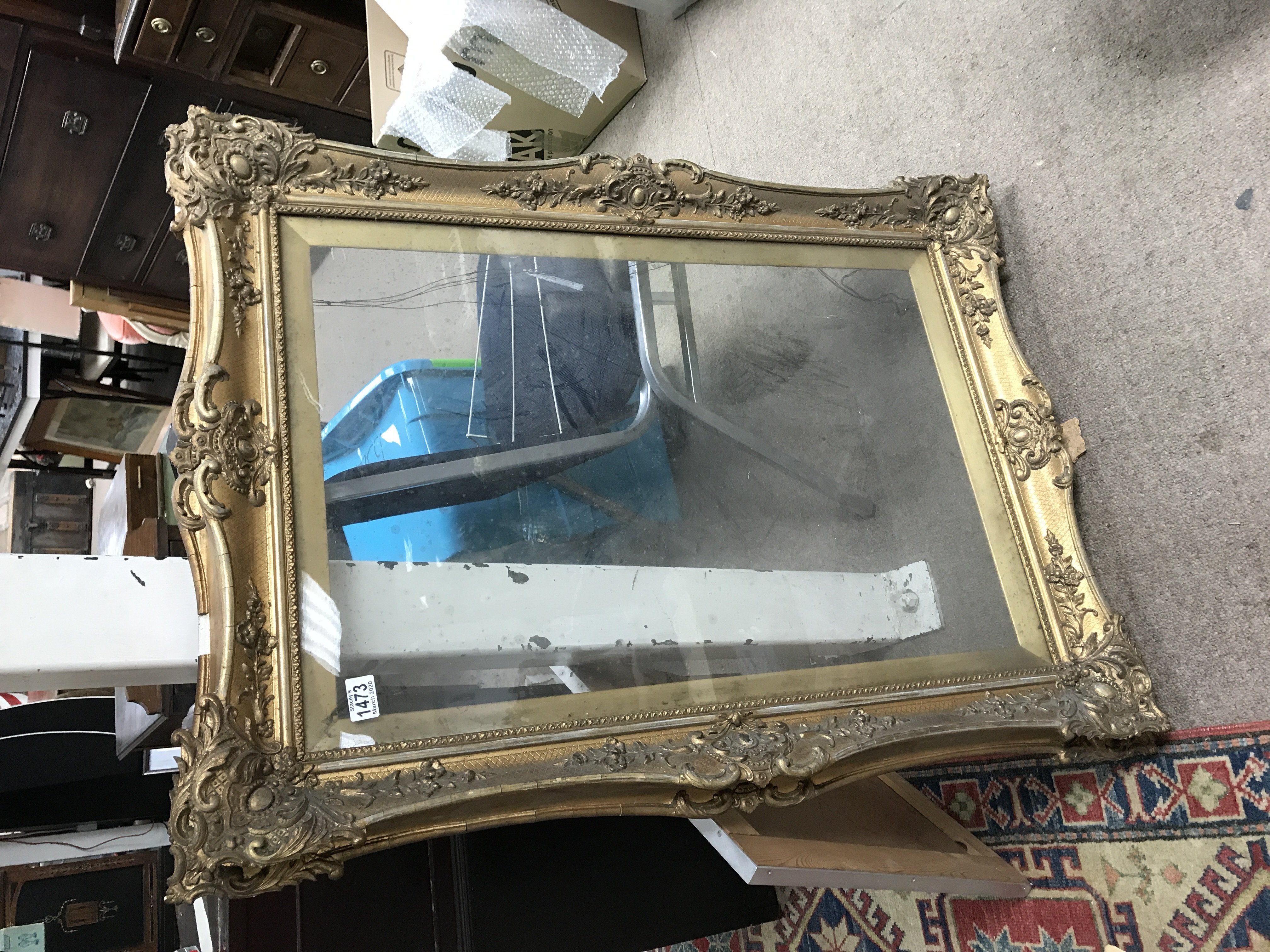 A large gilt and glazed picture frame.