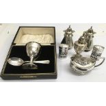 A group of silver cruets, a salt and cased eggcup.