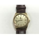 A gents Omega Seamaster watch with gold tone dial