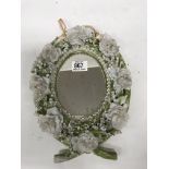 A fine porcelain floral decorated mirror.