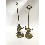 A pair of tall brass Roman style oil lamps