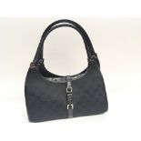 A Genuine Gucci Ladies Jackie black hand bag with