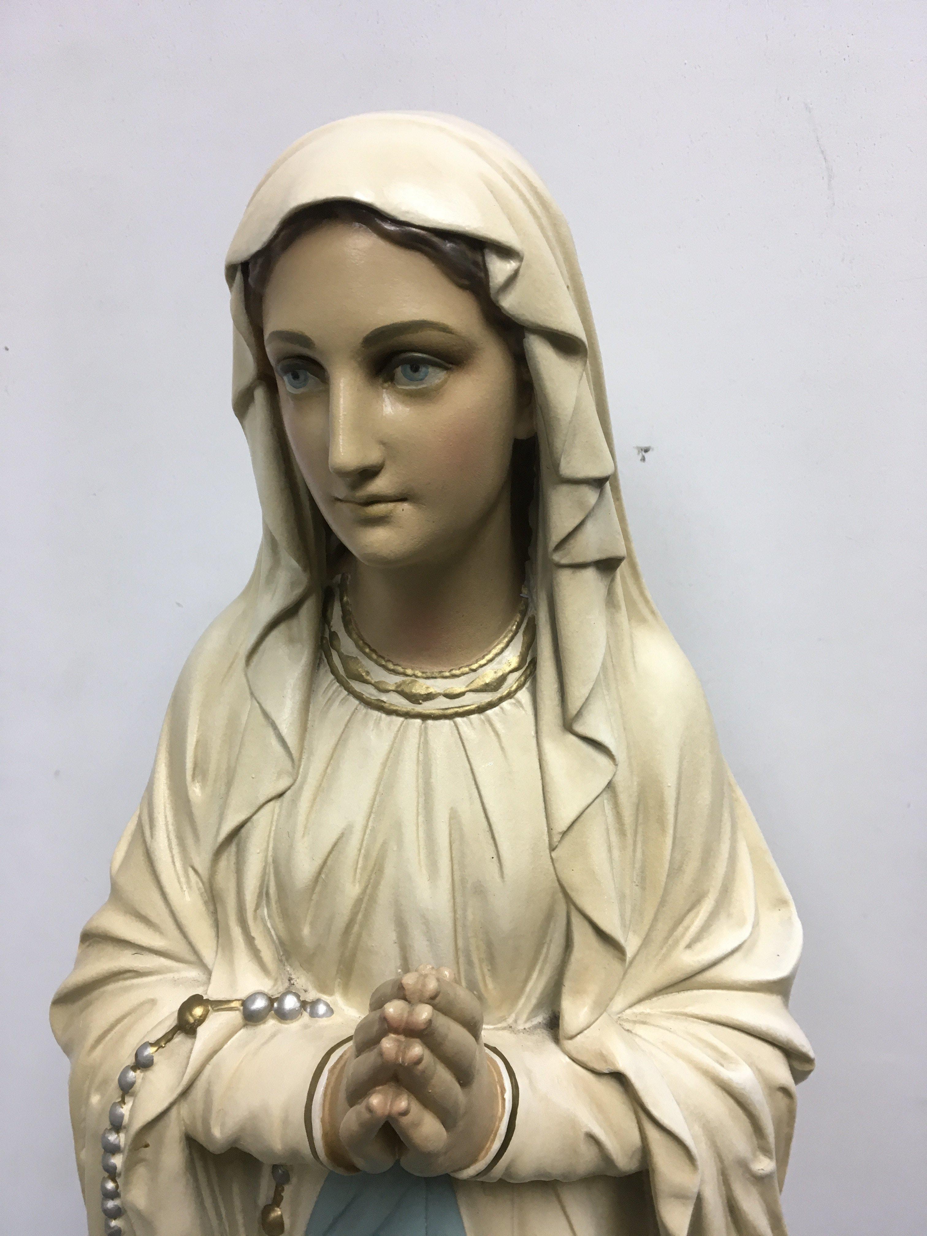 A large plaster figure depicting the Virgin Mary 1