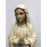 A large plaster figure depicting the Virgin Mary 1