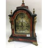 A ornate bracket clock with ormolu mounts the gilt arched dial with Roman numerals.the movement