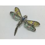 A silver dragonfly brooch set with cabochon sapphi