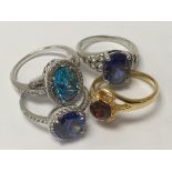 A collection of silver and gold tone rings