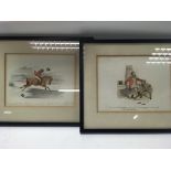 A pair of framed hunting pictures.
