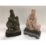 Two carved soapstone Oriental figures raised on ha