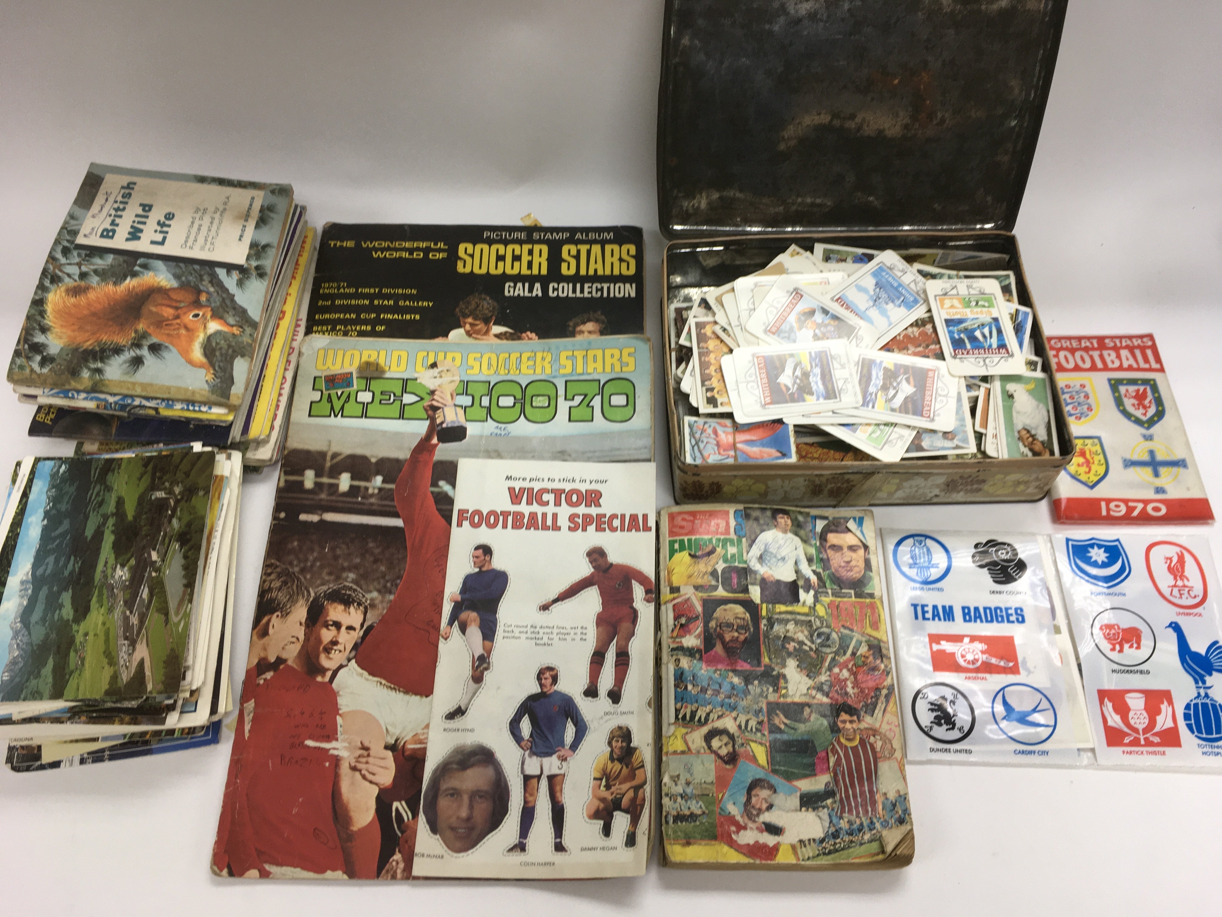 A collection of trading cards, tea cards and postc