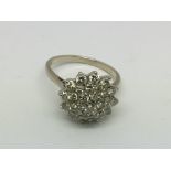 An 18ct white gold diamond cluster ring, approx 5.