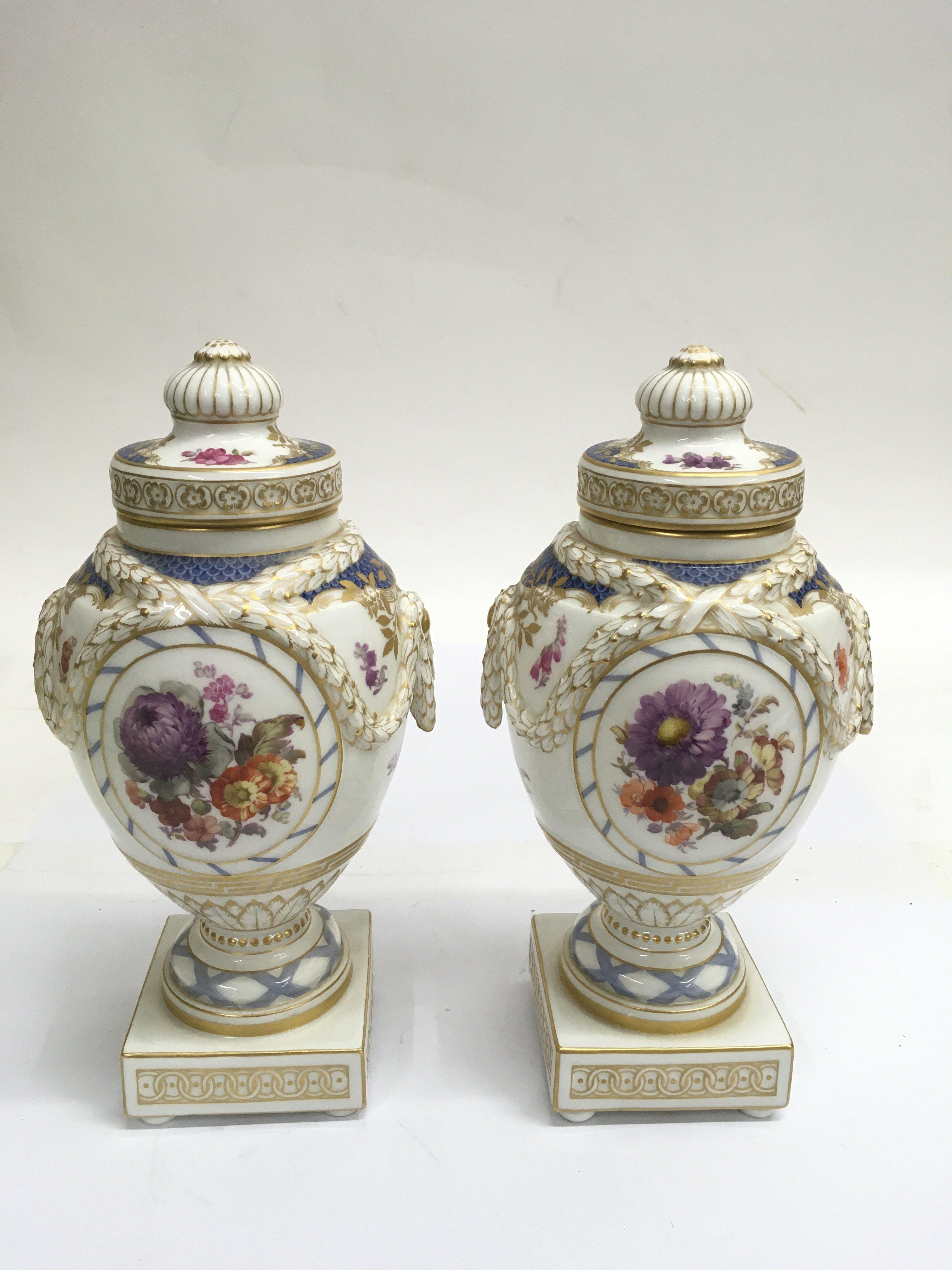 A fine pair of KPM porcelain lidded urns, of Class