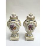 A fine pair of KPM porcelain lidded urns, of Class