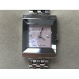 A boxed ladies Gucci watch with steel strap and pink face