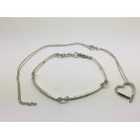 A silver and diamond bracelet and a silver heart shaped necklace (2).