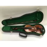 A cased circa 1900 French JTL 1/2 size violin, Compagnon label, plus a bow.