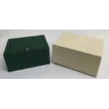 A green Rolex watch box with Oyster Perpetual book
