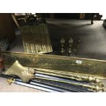 A Victorian brass fender, brass fire dogs, brass c