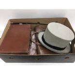 A small leather case, briefcase, grey top hat, whi