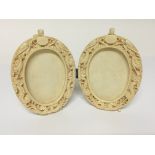 A late 19th Century Carved ivory double oval pictu