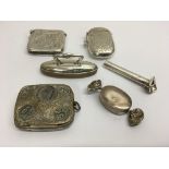 A bag of small silver items including vestas and a