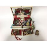 A jewellery box containing various costume jewelle