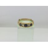 An 18ct gold ring set with alternating sapphires a