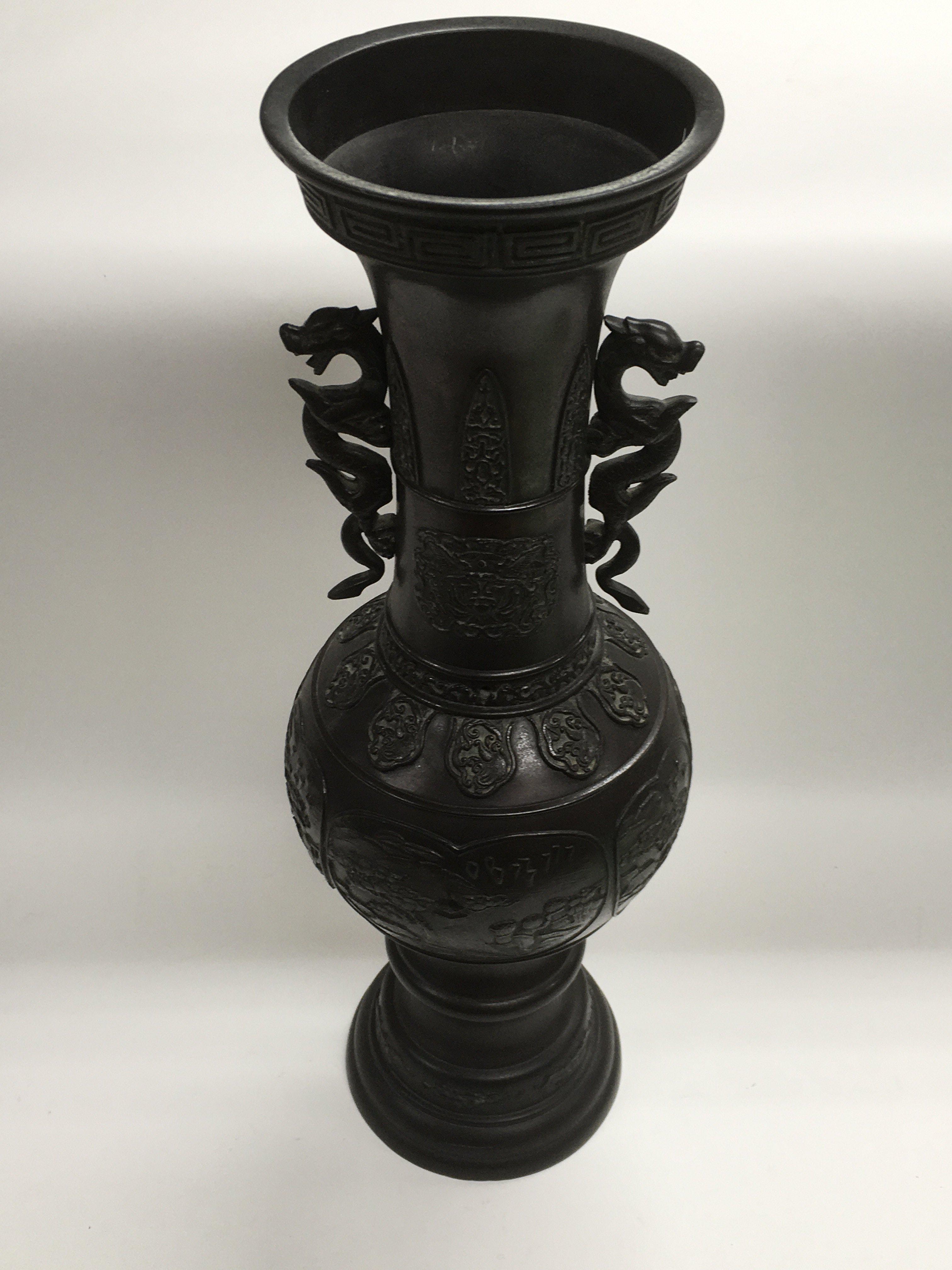 A Chinese bronze vase in two sections panelled dec