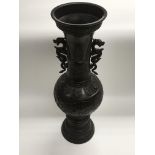 A Chinese bronze vase in two sections panelled dec