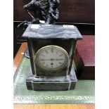 A small slate and marble mantle clock