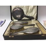 A silver backed dressing set including mirror and