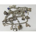Three hallmarked silver charm bracelets and charms