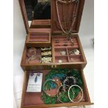 A birds eye maple jewellery box containing various costume jewellery items, mainly silver.