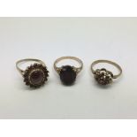 Three 9ct gold rings set with garnets, approx 8.4g
