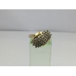 A14ct gold diamond cluster ring of modern design,