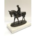 A bronze figure of a jockey on horseback, approx h