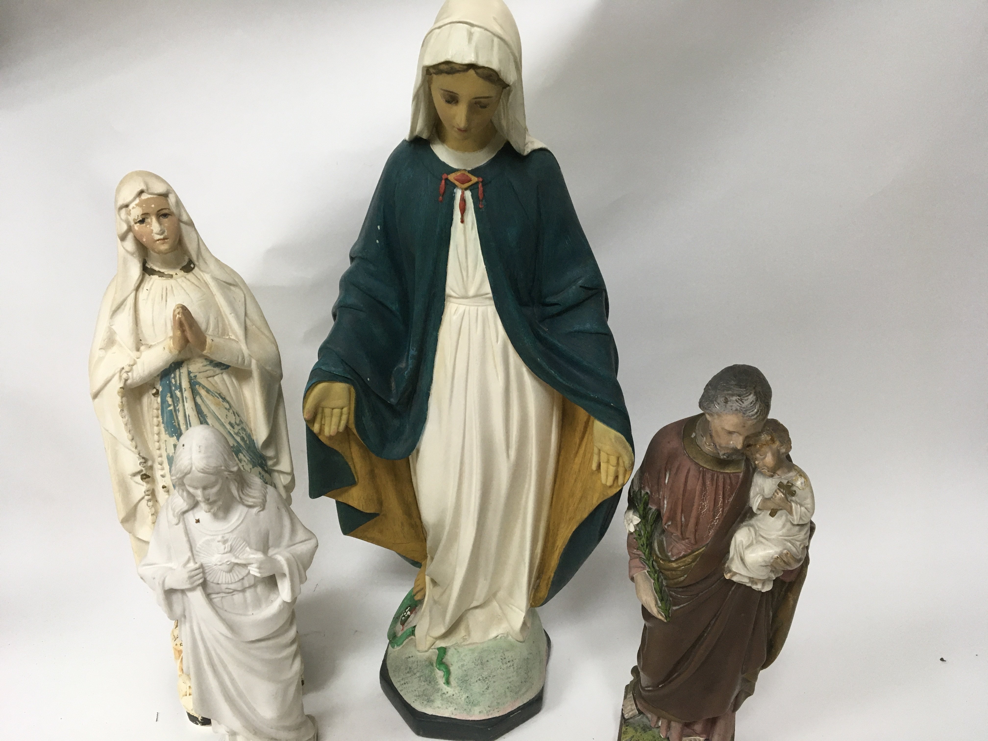 A collection of four religious plaster figures