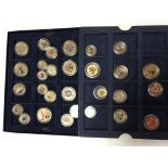 A box of mixed enamel coins