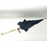 A 19th century silk parasol having carved ivory ha