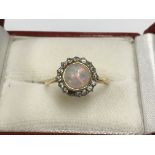 An 18ct gold untrusted opal and diamond ring (1 st