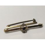 A 9 carat bar brooch set with a blue sapphire and