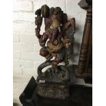 A carved and painted wooden figure of Ganesh. 59cm