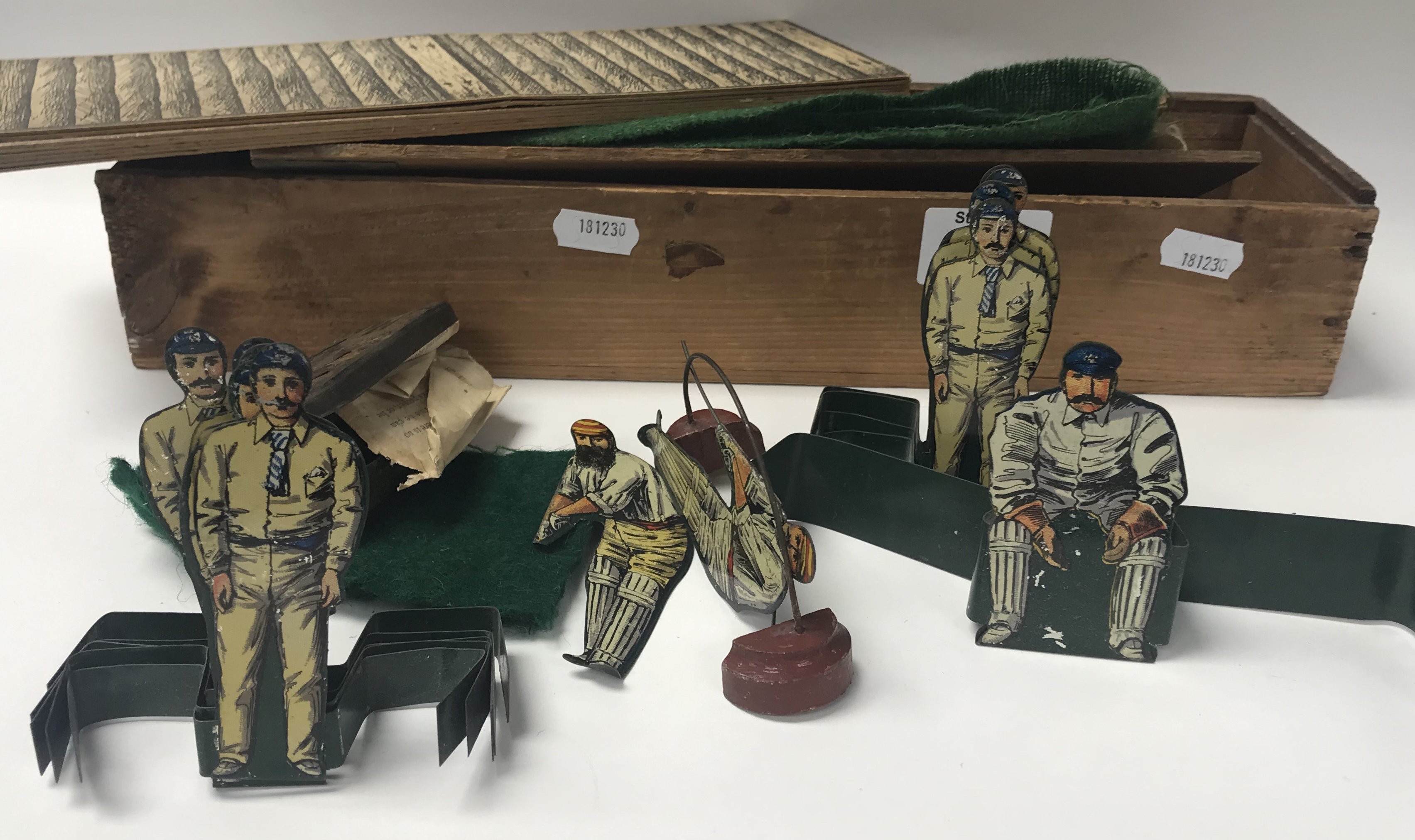 An early 20thC W.G Grace tinplate cricket game.