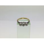 An 18ct gold ring set with three diamonds, approx