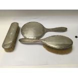 A silver dressing table set comprising hand mirror