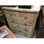 A 5 drawer pine chest of drawers.