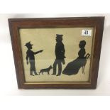 An oak framed silhouette of three Victorian figure