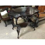 An ornate Victorian mahogany occasional table.